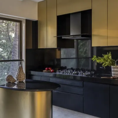 Behold, the Black & Gold Marvel. In this 2600 sq. ft. Mumbai duplex, I designed this kitchen to be an opulent oasis. The striking blend of sleek black finishes and lavish gold accents, crowned by a mesmerizing curved island, redefines luxury living.
