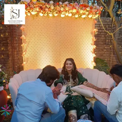 A beautiful seating area for the bride during her Mehandi ceremony. The backdrop of white flowers and lights, combined with a floral canopy, created a dreamy and elegant spot for her.