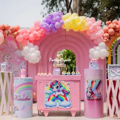 Kashni's unicorn party was a pastel dream. The main stage featured a large pink rainbow backdrop, adorable unicorn cutouts, and a beautiful balloon arch.