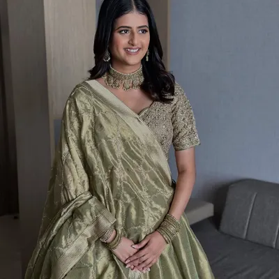 Bridal glam that listens, understands, and delivers. For her engagement, we chose a minimal look with glowing skin and soft definition to complement her elegant olive green lehenga.