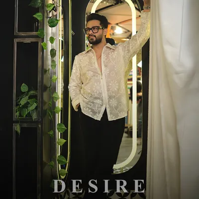 Transparency with intention. I designed this sheer white shirt with delicate floral embroidery for a look that is both confident and sophisticated. It is about showing strength in a subtle way.