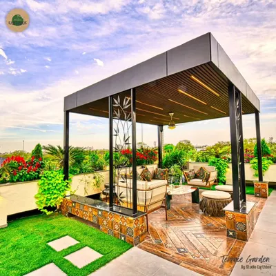 The heart of this terrace garden is the cozy seating area under a modern pergola. We added handcrafted metal art panels with a bamboo motif and a small water feature to create a warm, inviting oasis for our clients to unwind every day.
