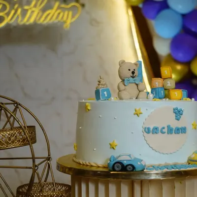 A close-up of a teddy bear-themed cake for a first birthday, showing the intricate details.