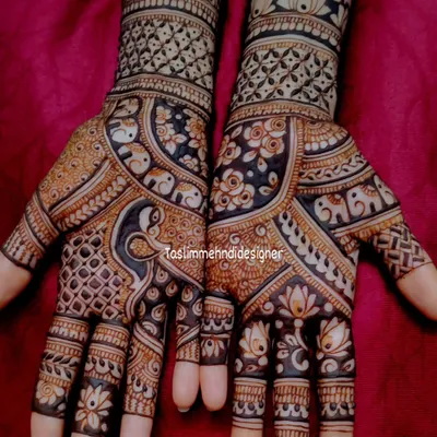 A close-up of a full-hand traditional design. The combination of peacocks, florals, and geometric checks creates a classic bridal look, and the dark stain is the result of my all-natural henna.