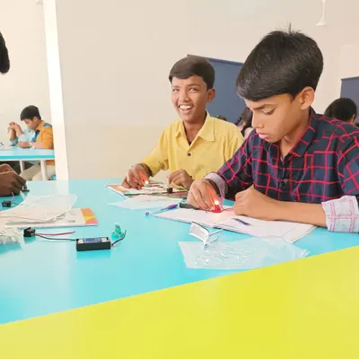 The smile of success! This student just completed his first circuit, and the bulb lit up. It's these moments of achievement that build confidence and a love for science.