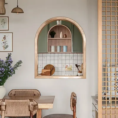 A small arched opening between the dining room and kitchen creates a beautiful connection between the two spaces. It frames the view into the kitchen like a piece of art and allows light and conversation to flow freely.