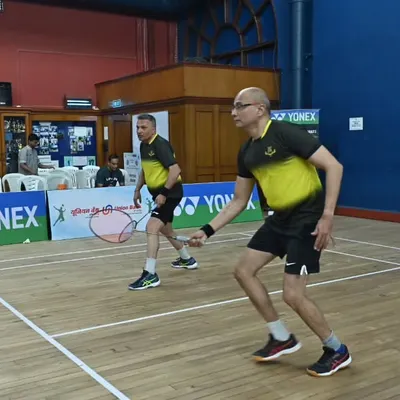 Two players in a doubles match during the GD Birla Masters Inter-Club Tournament. We organize competitive events for adults and veterans, focusing on high-quality gameplay and organization.