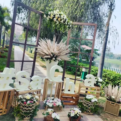 A personalized welcome setup featuring the couple's wedding hashtag. I used rustic wooden crates, pampas grass, and fresh flower baskets to create a trendy and welcoming decor piece.