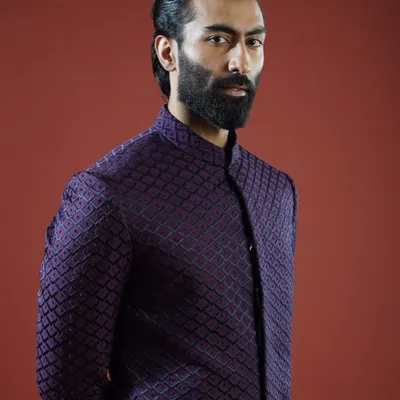 A deep purple Bandhgala jacket featuring a subtle, geometric texture. This piece is a prime example of modern sophistication, perfect for a cocktail evening or reception, offering a look that is both commanding and refined.