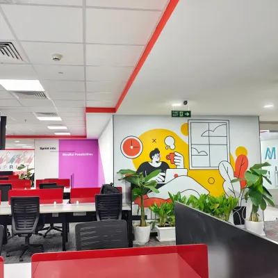 A view across the Mindsprint office, where we integrated playful wall murals and potted plants among the workstations. This approach adds personality and a touch of nature to the open-plan layout, making the space more engaging for employees.