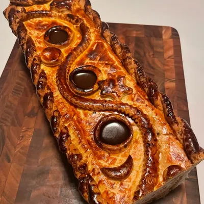 The top of my Pâté En Croute, showcasing the intricate pastry work and the rich, dark aspic set within the vents. This is a true labor of love.