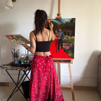 A view from behind the easel as I work on a custom couple's portrait. Using oil paints, I carefully build up the details of the figures and the lush garden background to create a piece they'll cherish.