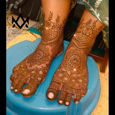 A classic bridal foot mehendi design, with a central mandala and detailed patterns covering the entire foot and toes.