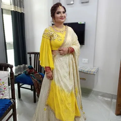 This client was getting ready to celebrate her first wedding anniversary. Here is her full look, featuring a beautiful yellow and white lehenga, traditional red bangles, and makeup designed to last through the celebration.
