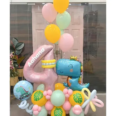 A roar-some dinosaur bouquet for Aahana's 4th birthday. This cute and colorful arrangement features a friendly T-rex, a personalized number balloon, and tropical leaf details for a prehistoric party vibe.