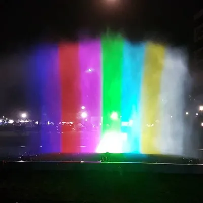 We transform water into a dynamic canvas for light and color. This image captures our water screen projection technology, where high-powered projectors display vibrant visuals onto a fine mist. The result is a stunning, holographic-like effect ideal for large-scale outdoor events, brand activations, and public festivals.