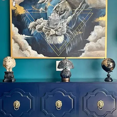 This commissioned acrylic painting captures the powerful yet serene energy of a lion. I used a combination of deep blues and metallic gold accents to create a piece that feels both majestic and integrated into the client's beautiful home decor.