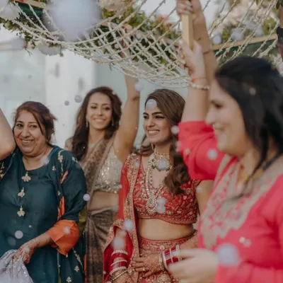 The real bridal glow begins with mehendi. This bride's radiant smile during her entrance, with her hands adorned in henna, captures the love, patience, and tradition that make a wedding so beautiful.