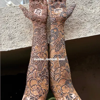 A full-coverage bridal design shown in natural light, highlighting the contrast and detail. The pattern combines geometric fills with soft, shaded floral work.