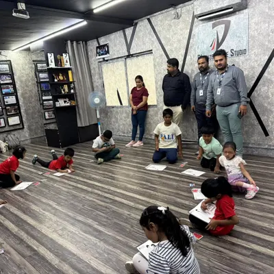A behind the scenes look at our kids' coloring competition. Campers are spread out on the studio floor, completely absorbed in their artwork.