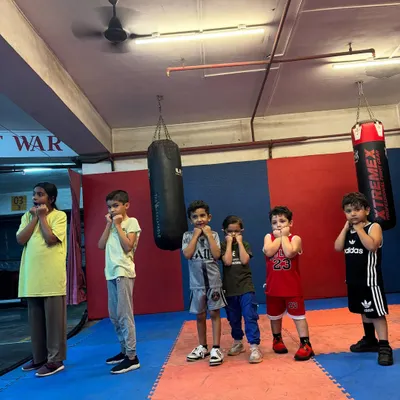The future of boxing starts here. A group of our young students stands ready, learning the basic defensive guard position. I teach them the importance of a solid foundation from day one.