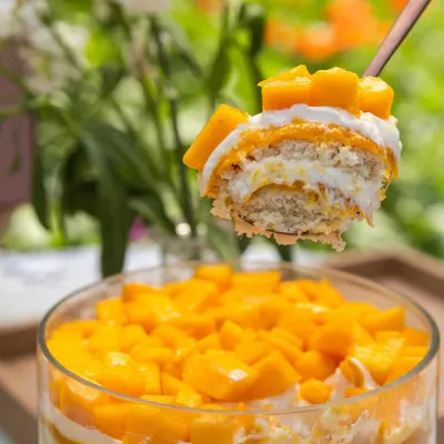 A spoonful of summer. This is my Mango Cream Cheese Trifle, showing the layers of soft cake, light cream cheese, and sweet, fresh mango.