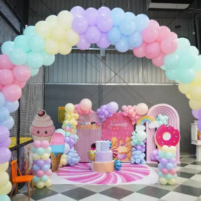 Welcome to a candy-themed dreamland! This stunning setup with pastel balloon arches and giant ice cream props shows how we transform our space for a truly sweet and memorable birthday celebration.