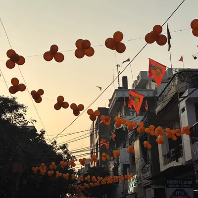 This is an outdoor decoration I did for a religious event. I strung clusters of saffron-colored balloons across the street, creating a festive canopy for the entire neighborhood to celebrate together.