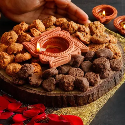 A beautiful Diwali-themed platter featuring healthy cookies and a traditional diya. This image combines festive elements with the product to create a perfect visual for holiday marketing.