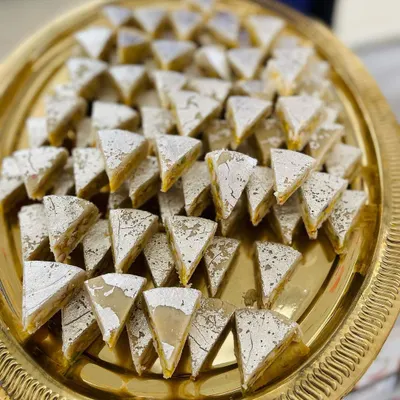 This is our unique Dryfruit Sandwich, a multi-layered sweet that is a feast for the eyes and the palate. It's a popular choice for wedding sweet platters and as a standout item in our assorted gift boxes.