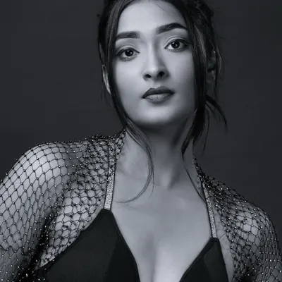 A classic black and white headshot with a direct, engaging gaze. This monochrome portrait is perfect for a model's portfolio, emphasizing natural features and expression.