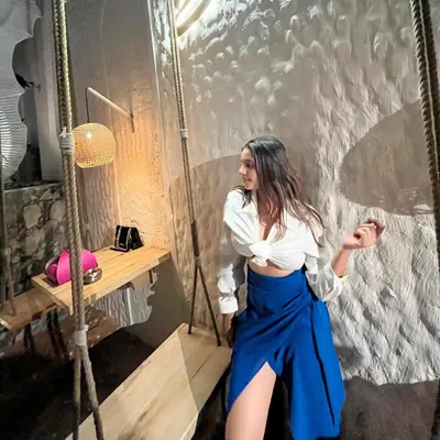 A candid moment from my birthday. My personal style is about comfort and ease, like this simple white tie-front shirt paired with a bold blue wrap skirt.