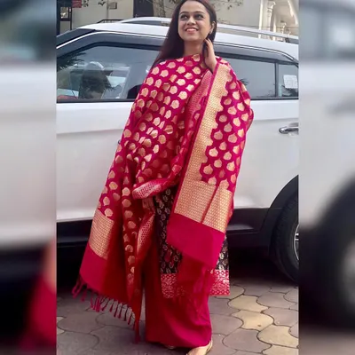 A vibrant Benarasi dupatta is a must-have for any festive wardrobe. It instantly adds a touch of luxury and tradition to a simple suit, making it perfect for a puja or a wedding function. I help clients find these key investment pieces.