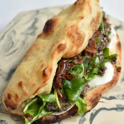 Our Mushroom Duxelles Sourdough Pizza Sandwich from the Spanish mini-edit. It's packed with flavor from caramelized onions, arugula, mozzarella, and a hint of truffle oil.