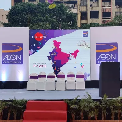 This stage for AON's annual event was designed for maximum brand impact. The central LED screen displayed key event graphics, while the side panels were clearly branded with the company logo, ensuring a professional backdrop for all speakers and presentations.