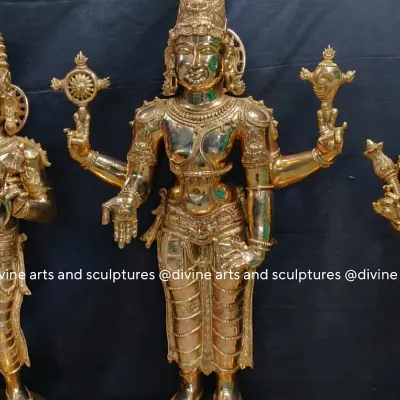 This is the central figure of Lord Balaji from a three-piece set, cast in polished bronze. He is shown with four arms, holding the Sudarshana Chakra and Panchajanya conch, with his lower hands in the varada and katyavalambita mudras.