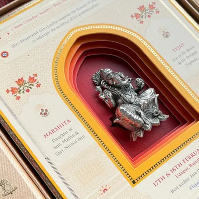A stunning multi-layered invitation featuring a silver Ganesha idol. This piece, created for our clients by Uttara Shah, is a beautiful example of blending tradition with intricate design.