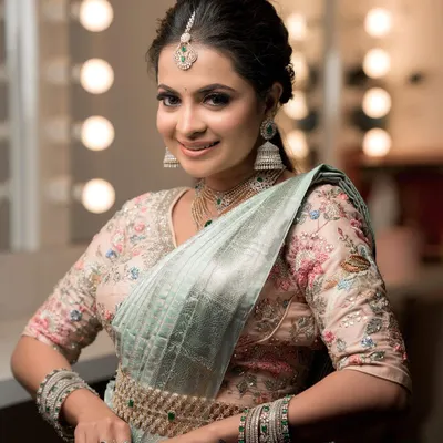 For receptions or modern events, I offer stunning American Diamond sets like this one. This multi-layered necklace, paired with a delicate maang tikka and matching jhumkas, provides exceptional sparkle and is designed to complement contemporary sarees and gowns beautifully.