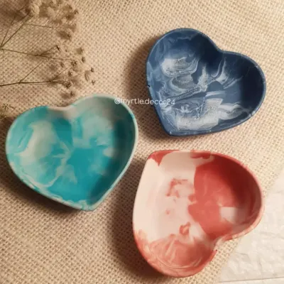 Our mini heart dishes in beautiful marbled shades of aqua, blue, and pink. These are the perfect little catch-alls for the small things you use daily, like rings and earrings, and they make any space look extra cute.