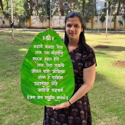 Here I am with a large, 24-inch 'Vadani Kaval' wall hanging, custom-made for a client in the US. This traditional Marathi prayer for mealtime looks beautiful in a dining area.