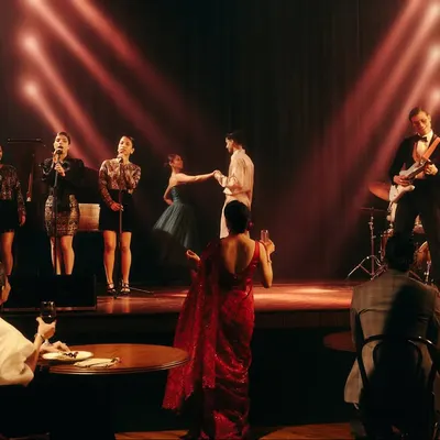 A wide shot from the Origin & Ode jazz bar campaign, establishing the entire scene. My role was to direct the creative vision, styling each character from the audience to the band to create a cohesive and believable world.