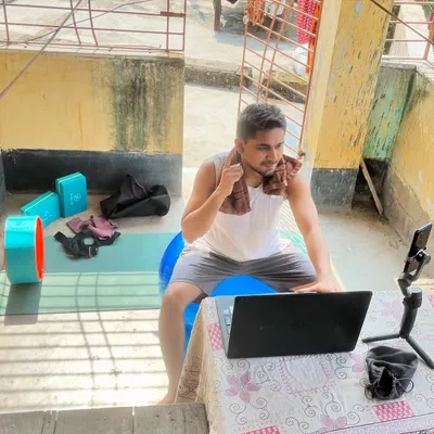 Here is my setup for an online fitness session. I connect with students from all over, providing live feedback and motivation through my laptop and phone.