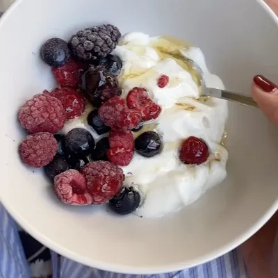 A perfect post-training recovery meal doesn't have to be complicated. This bowl of Greek yogurt with mixed berries and a drizzle of honey provides a great balance of protein to repair muscles and carbohydrates to replenish energy stores. Plus, the antioxidants in the berries help reduce inflammation.