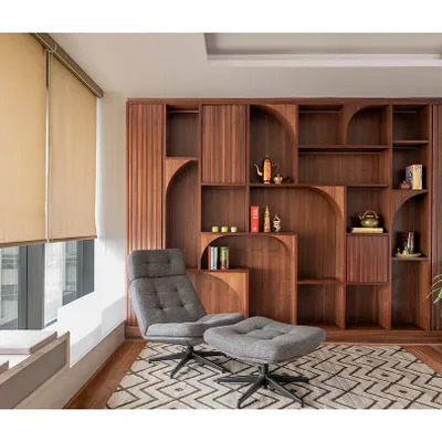 The wellness zone in 'The Office with A View' is a quiet, secluded room for staff to unplug. It features comfortable furniture, a custom bookshelf, and a window seat with an integrated planter box.