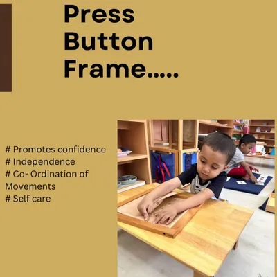 A child masters the press button frame, a practical life activity that develops fine motor skills, coordination, and independence in self-care.