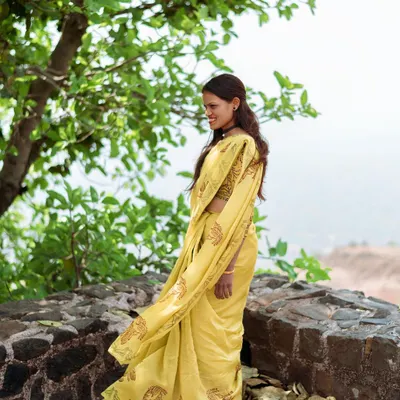 A candid portrait of a smiling woman artisan in Dhar, Madhya Pradesh, captured in a natural outdoor setting.