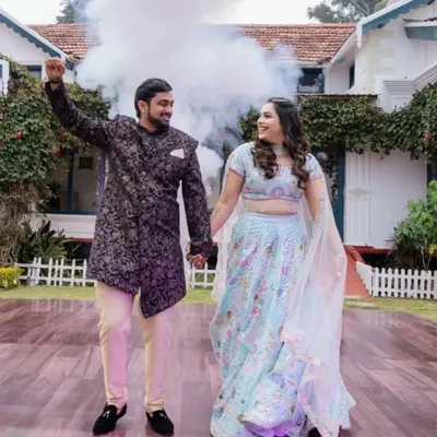 A picture-perfect moment for the couple at their Ooty destination wedding, with a color bomb adding a splash of fun to their photoshoot.