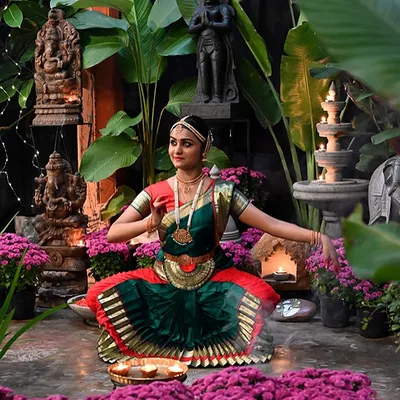 A scene from our store during the festive season, where our handcrafted decor is brought to life with flowers, light, and classical dance.