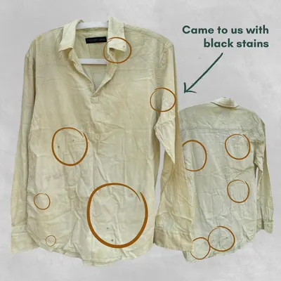 This shirt came to us with several black stains. Instead of discarding it, we saw an opportunity for transformation. This is the first step in our Resurrect service, where we assess a garment to plan its new design.