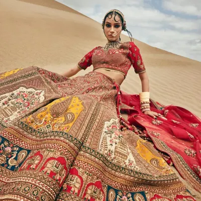 This multi-colored lehenga with traditional motifs is a masterpiece for any royal-themed shoot. The vibrant colors and detailed embroidery ensure you look like royalty in your pre-wedding photos.